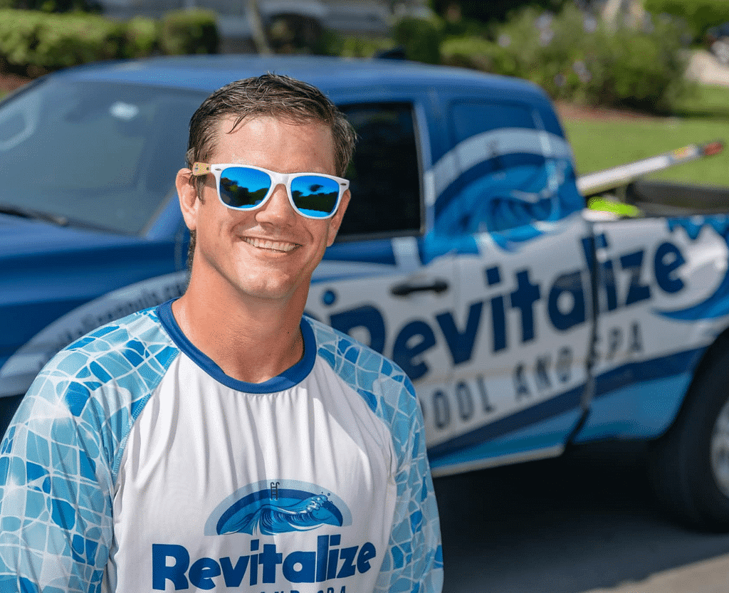 Evan King standing proudly in front of Revitalize pool and spa van